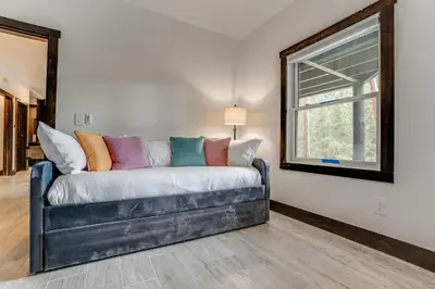 a couch in a living room with a window at Keystone 5BD 5 5BT Luxury Remodel 2025 & Pets in Keystone