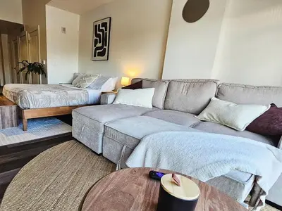 a living room with a couch and a bed at Cherry Creek Rooftop Oasis in Denver