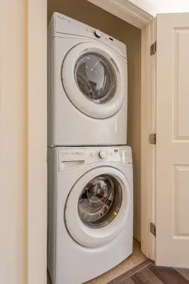 a washer and dryer stacked on top of each other at Cherry Creek Rooftop Oasis in Denver