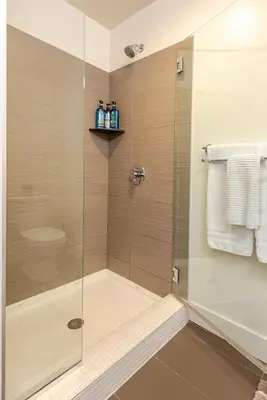a shower with a glass door in a bathroom at Cherry Creek Rooftop Oasis in Denver