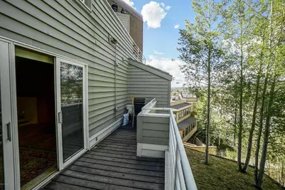a porch of a house with a balcony at Downtown Luxury + Hot Tubs; Walkable Winter Park in Winter Park