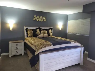 a bedroom with a large bed and a night stand at Comfortable 1 Bed 1 Bath Loft in Uptown Denver in Denver