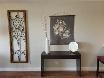 a table with a vase on it next to a mirror at Comfortable 1 Bed 1 Bath Loft in Uptown Denver in Denver