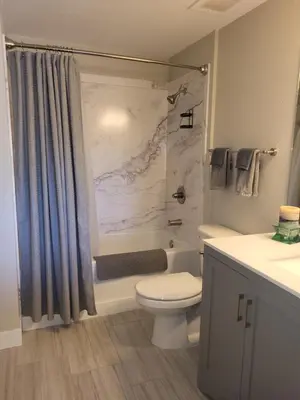 a bathroom with a toilet and a tub and a sink at Comfortable 1 Bed 1 Bath Loft in Uptown Denver in Denver
