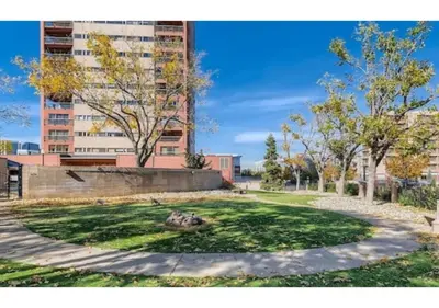 a park in front of a tall building at Comfortable 1 Bed 1 Bath Loft in Uptown Denver in Denver