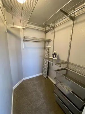 a walk in closet with metal shelving at Comfortable 1 Bed 1 Bath Loft in Uptown Denver in Denver