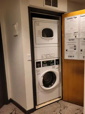 a washing machine and a washer and dryer in a room at Comfortable 1 Bed 1 Bath Loft in Uptown Denver in Denver