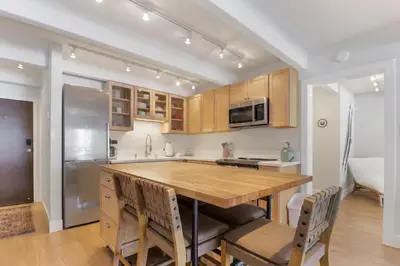 a kitchen with a wooden table and a refrigerator at 317 Lodge at Lake Dillon condo in Dillon