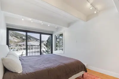 a bedroom with a bed and a large window at 317 Lodge at Lake Dillon condo in Dillon