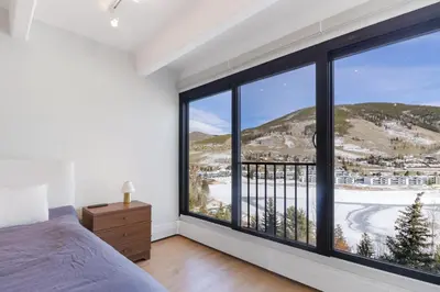 a bedroom with a bed and a large window at 317 Lodge at Lake Dillon condo in Dillon