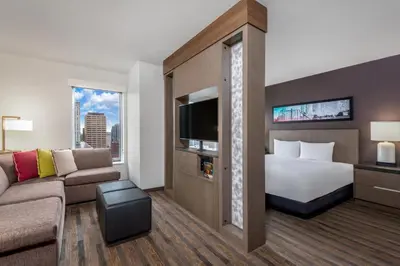 a hotel room with a bed and a couch at Hyatt House Denver Downtown in Denver