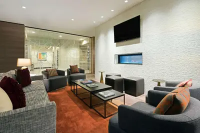 a living room with couches and a flat screen tv at Hyatt House Denver Downtown in Denver