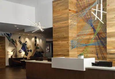 a lobby with a wall of wood at Hyatt House Denver Downtown in Denver