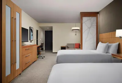 a hotel room with two beds and a television at Hyatt Place Denver Downtown in Denver