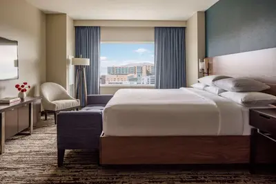 a hotel room with a large bed and a window at Hyatt Regency Aurora-Denver Conference Center in Aurora