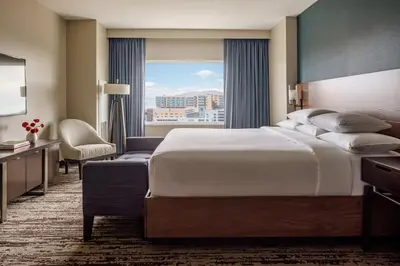a hotel room with a large bed and a window at Hyatt Regency Aurora-Denver Conference Center in Aurora