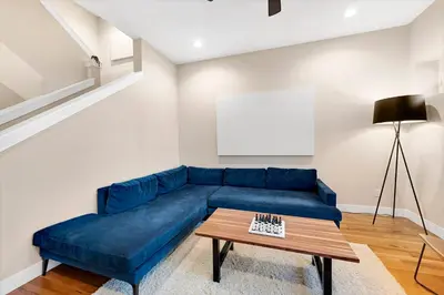 a blue couch in a living room with a table at Townhouse in Santa Fe Arts District in Denver