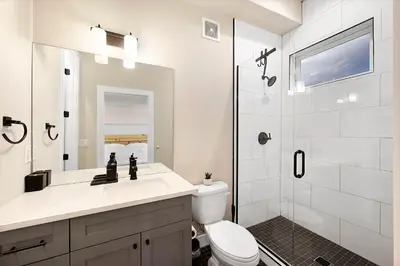 a bathroom with a sink and a toilet and a shower at Townhouse in Santa Fe Arts District in Denver