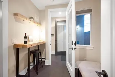 a small kitchen with a table and a bottle of wine at Townhouse in Santa Fe Arts District in Denver
