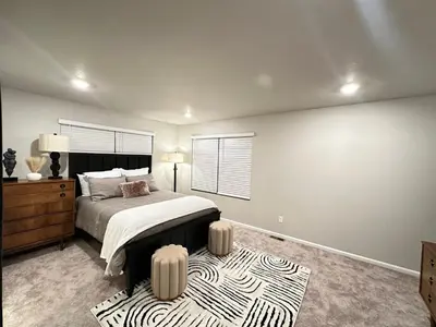 a bedroom with a bed and a zebra rug at New Vacation Home 8 min walking distance from Gaylord Hotel in Aurora