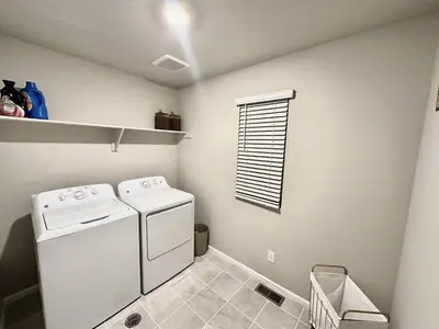 a laundry room with a washer and dryer at New Vacation Home 8 min walking distance from Gaylord Hotel in Aurora