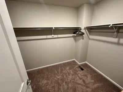 a room with a walk in closet with a shelf at New Vacation Home 8 min walking distance from Gaylord Hotel in Aurora