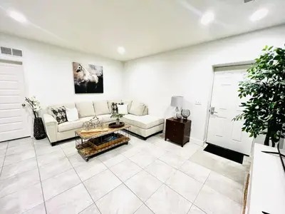 a living room with a couch and a table at Entire Fully Equipped Basement Guest Apartment Home in DEN