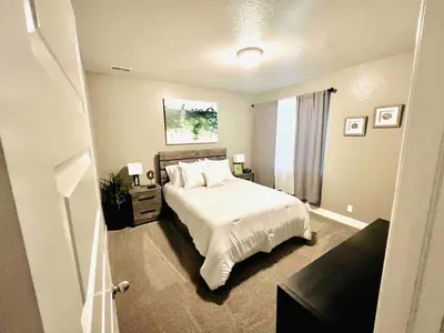 a bedroom with a white bed and a window at Entire Fully Equipped Basement Guest Apartment Home in DEN