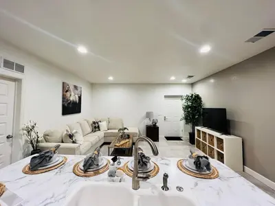 a living room with a sink and a couch at Entire Fully Equipped Basement Guest Apartment Home in DEN