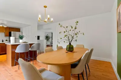 a dining room and kitchen with a wooden table and chairs at Game Room • Fire Pit • Arcade • Outdoor Dining in Arvada