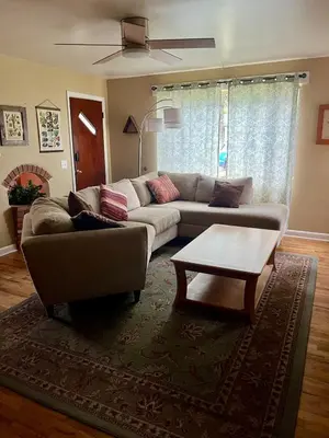 a living room with a couch and a coffee table at Little Brick House- pet friendly in Loveland