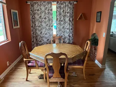 a dining room with a table and chairs and a window at Little Brick House- pet friendly in Loveland
