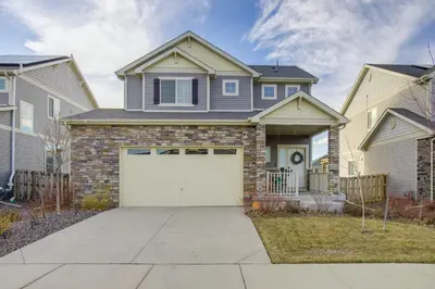 a house with a white garage door at Home Gym and Fenced Backyard Aurora Family Home! in Aurora