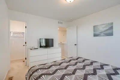 a bedroom with a bed and a flat screen tv at Home Gym and Fenced Backyard Aurora Family Home! in Aurora
