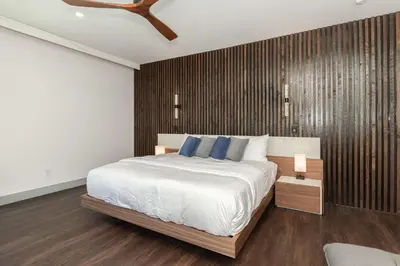 a bedroom with a large bed with blue pillows at Dilly Dally Chalet in Winter Park
