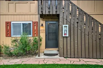 a front door of a house with a pay phone at Estes Escape-Walk Downtown - Free Mountain Coaster in Estes Park
