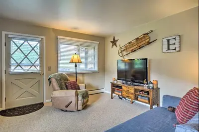 a living room with a tv and a couch at Estes Escape-Walk Downtown - Free Mountain Coaster in Estes Park