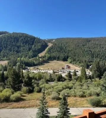 a view of a mountain with trees and a parking lot at Renovated 3BR Mountain Condo - Kids Ski Free condo in Keystone