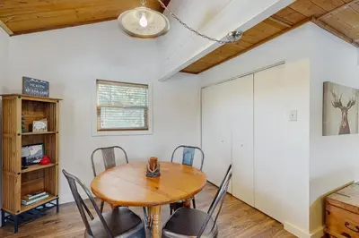 a dining room with a wooden table and chairs at The Meandering Moose in Grand Lake