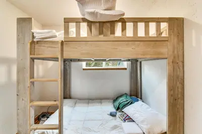 a bunk bed in a room with a bunk bedutenewayewayprefixprefixprefix at Wooded Retreat with Private Hot Tub in Evergreen in Evergreen
