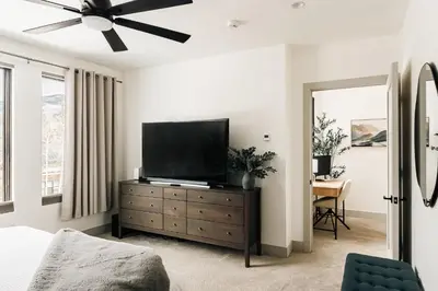a bedroom with a flat screen tv on a dresser at Modern Mountain Townhome - Rooftop Hot Tub in Silverthorne