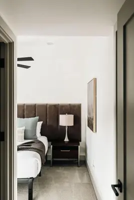a bedroom with a bed and a table with a lamp at Modern Mountain Townhome - Rooftop Hot Tub in Silverthorne