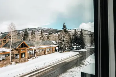 a view from a window of a snow covered street at Modern Mountain Townhome - Rooftop Hot Tub in Silverthorne