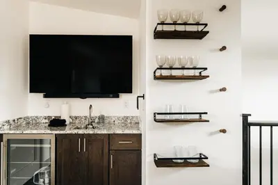 a bathroom with a sink and a tv on a wall at Modern Mountain Townhome - Rooftop Hot Tub in Silverthorne