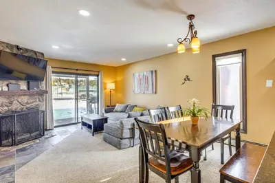 a living room with a table and a couch at Cozy Condo Steps to Free Winter Park Shuttle! in Fraser