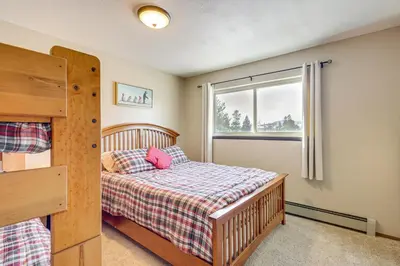 a bedroom with a bed and a window at Cozy Condo Steps to Free Winter Park Shuttle! in Fraser