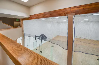 a volleyball court in a gym with a net at Cozy Condo Steps to Free Winter Park Shuttle! in Fraser