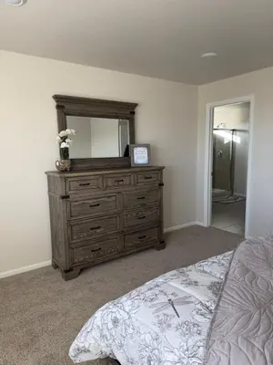 a bedroom with a dresser with a mirror on it at Bsnsn in Commerce City