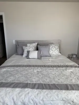 a large bed with several pillows on top of it at Bsnsn in Commerce City