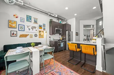 a kitchen and living room with a table and chairs at Bright 1BR Office, Attached Garage & Fast WiFi in Denver